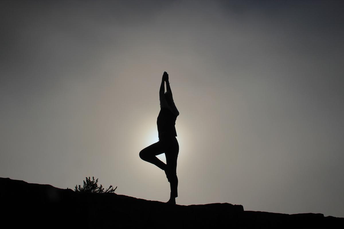 A person practicing yoga with a serene background