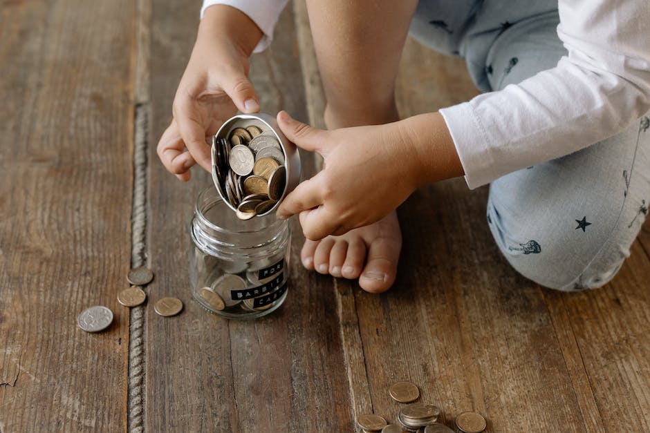An image showing a person organizing coins in different jars representing various spending categories for budgeting.