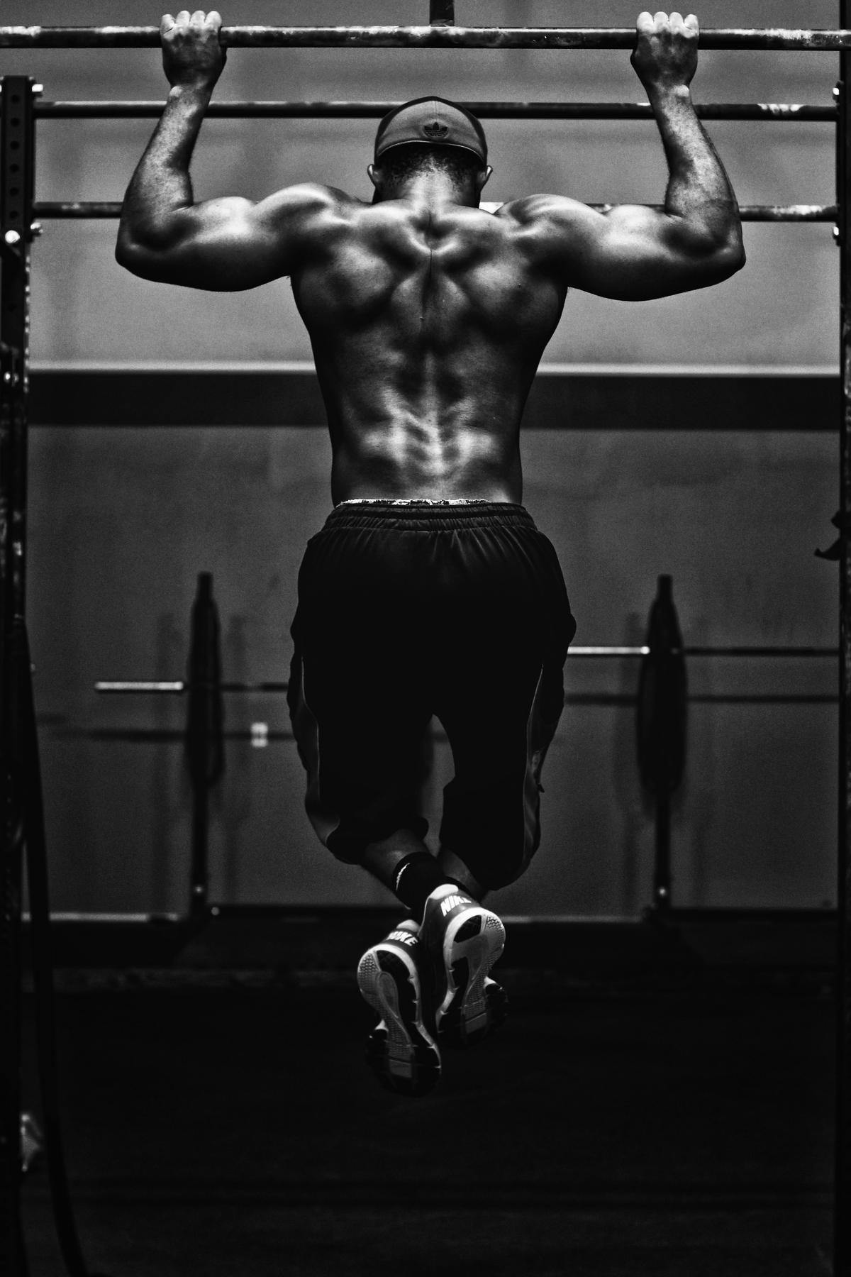 Image of a person working out in a gym, representing the importance of following a personal training schedule