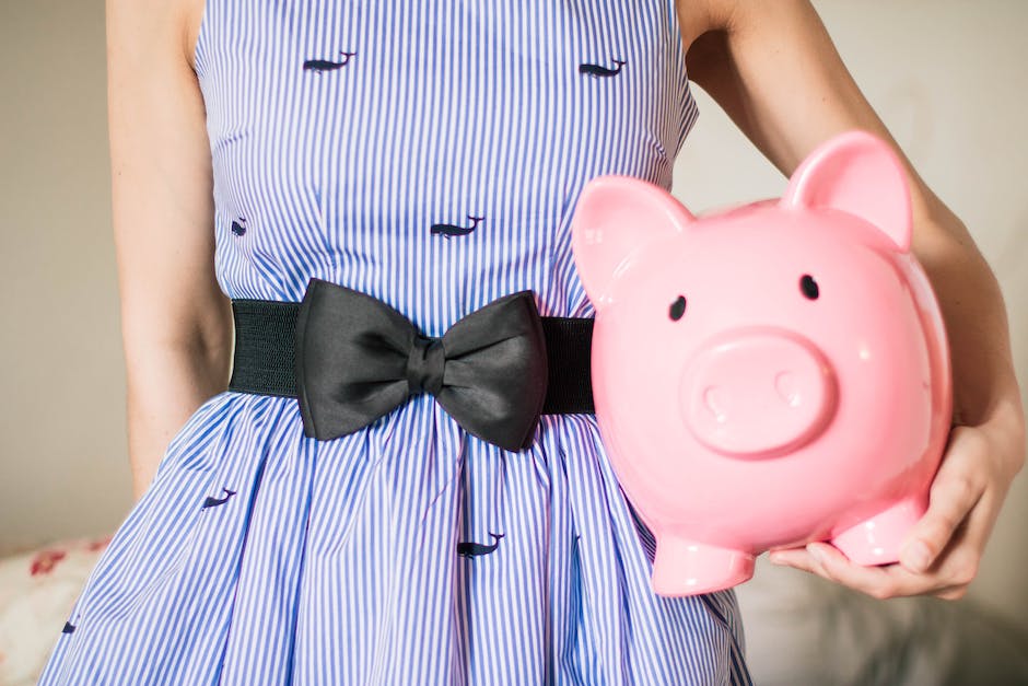 Image of a person holding a piggy bank, representing frugal living and financial savings
