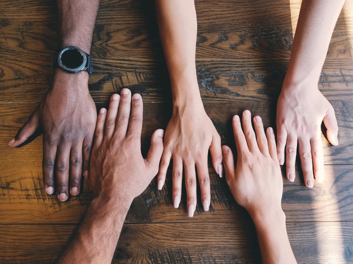 Illustration of diverse hands supporting each other, symbolizing a support system